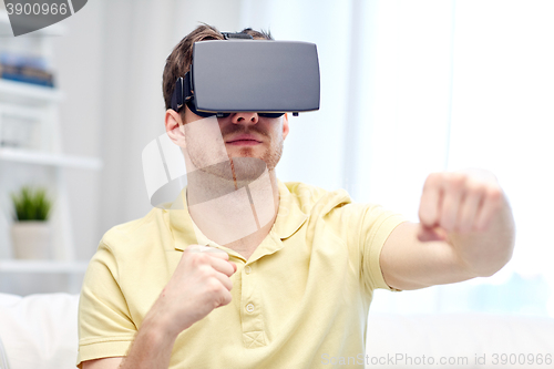 Image of young man in virtual reality headset or 3d glasses