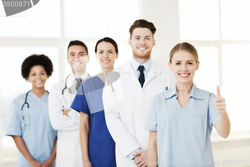 Image of happy doctors showing thumbs up at hospital