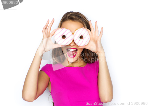 Image of happy woman or teen girl looking through donuts