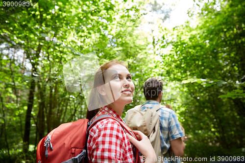 Image of group of smiling friends with backpacks hiking