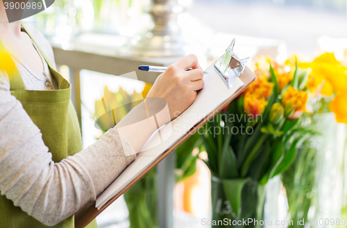 Image of close up of woman with clipboard at flower shop