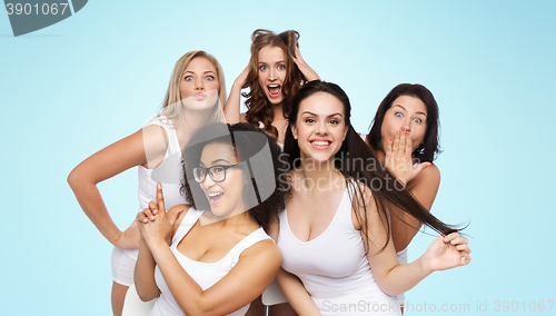 Image of group of happy women in white underwear having fun