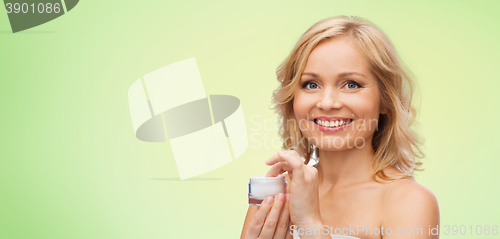 Image of happy woman with cream jar