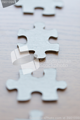 Image of close up of puzzle pieces on wooden surface