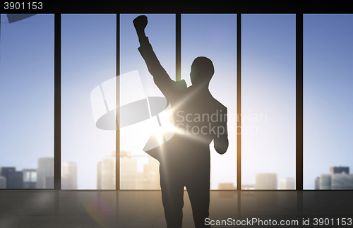 Image of silhouette of business man over office background