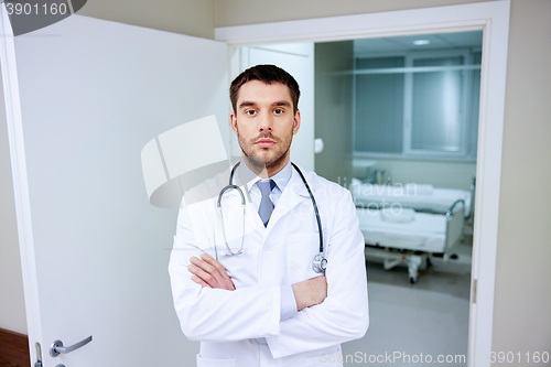 Image of doctor with stethoscope at hospital corridor