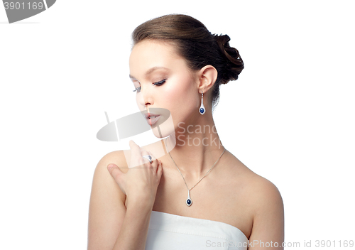 Image of beautiful woman with earring, ring and pendant