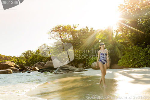 Image of A beautiful woman walking on the beach