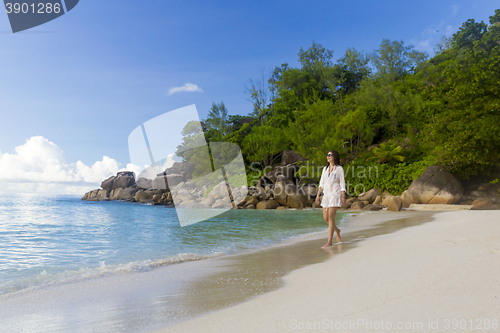 Image of A beautiful woman walking on the beach