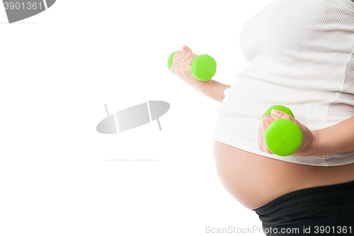 Image of Pregnant girl lifting dumbbells isolated on white