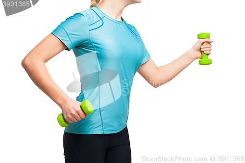 Image of Athletic woman works out with green dumbbells