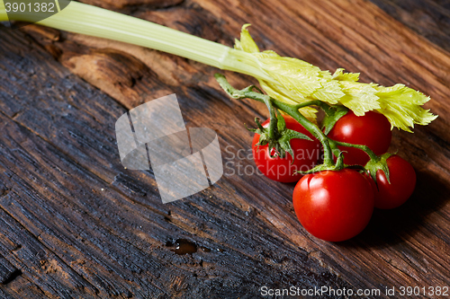 Image of Fresh Raw Celery and Tomatoes Vegetable on Brown Wooden background