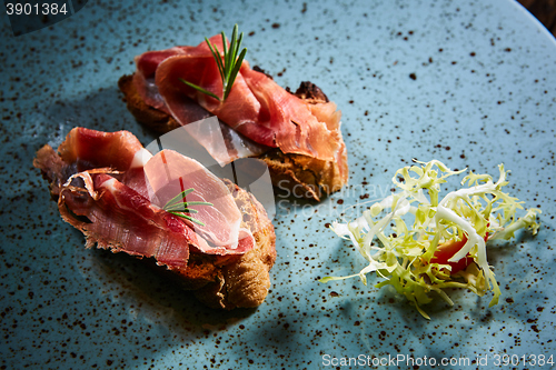 Image of Two slice of Spanish tapas with jamon