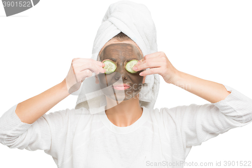 Image of Young beautiful woman in mask for the face. therapeutic black clay. Spa treatment.