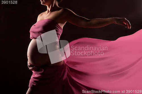 Image of Beautiful pregnant woman in pink chiffon shawl