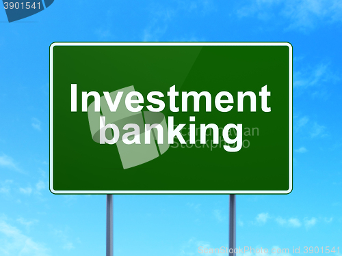 Image of Currency concept: Investment Banking on road sign background