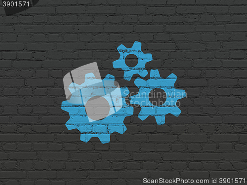 Image of Information concept: Gears on wall background