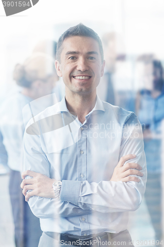 Image of group of smiling businesspeople meeting in office