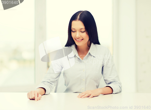 Image of smiling woman pointing to something imaginary