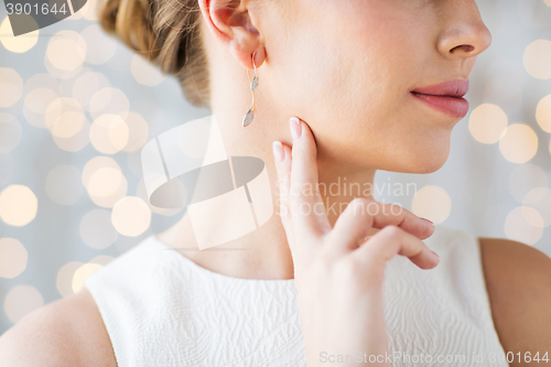 Image of close up of beautiful woman face with gold earring