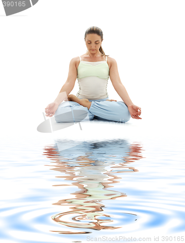 Image of padmasana lotus pose on white sand