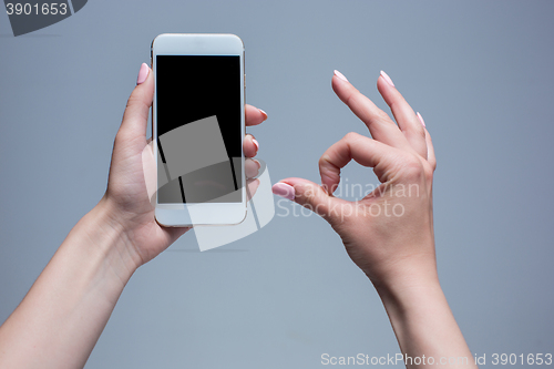 Image of Closeup shot of a woman typing on mobile phone 