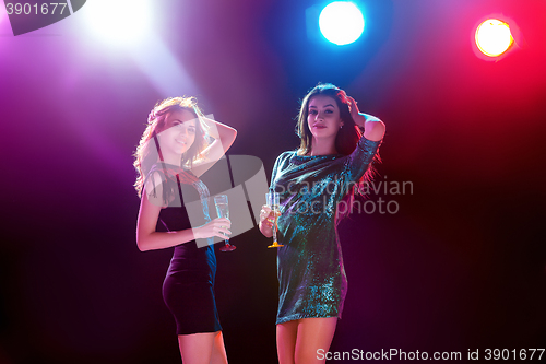 Image of Two beautiful girls dancing at the party