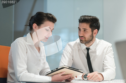 Image of young business couple working together on project