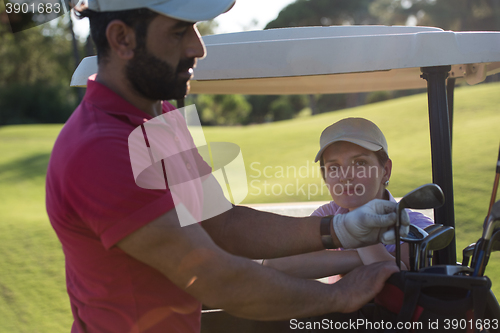 Image of couple in buggy on golf course