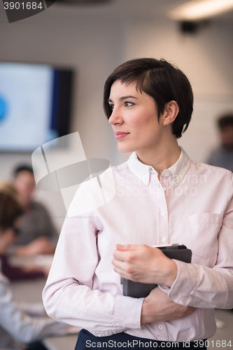 Image of hispanic businesswoman with tablet at meeting room