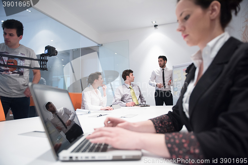 Image of young business woman on meeting  using laptop computer