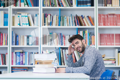 Image of portrait of student while reading book  in school library