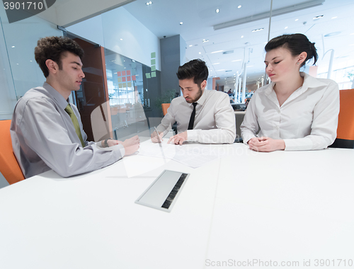 Image of young couple signing contract documents on partners back