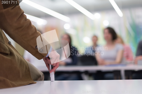 Image of close up of teacher hand while teaching in classroom