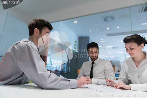 Image of young couple signing contract documents on partners back