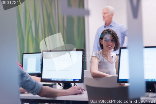 Image of technology students group in computer lab school  classroom