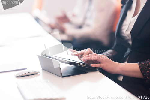 Image of business woman on meeting  using tablet