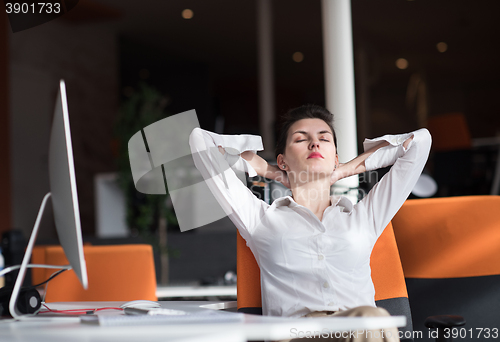 Image of happy young business woman relaxing and geting insiration