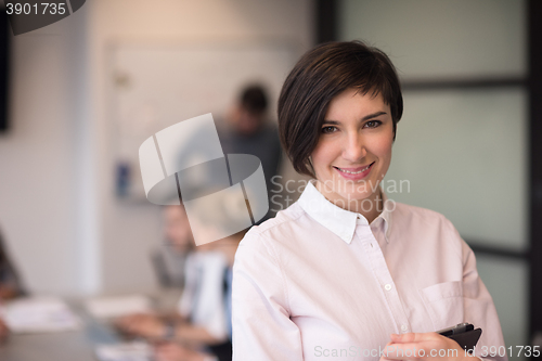 Image of hispanic businesswoman with tablet at meeting room