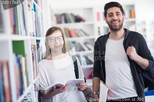 Image of students couple  in school  library