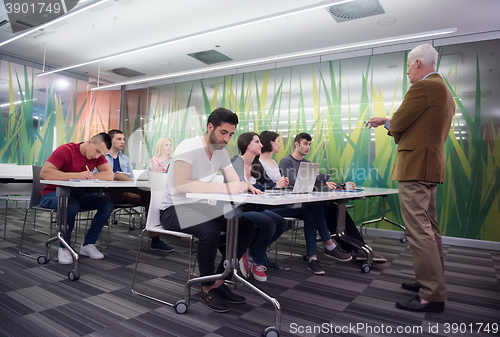 Image of teacher with a group of students in classroom