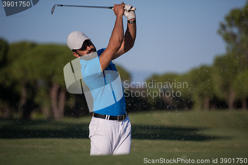 Image of pro golfer hitting a sand bunker shot