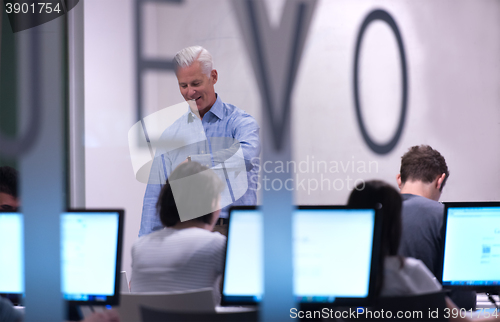 Image of teacher and students in computer lab classroom