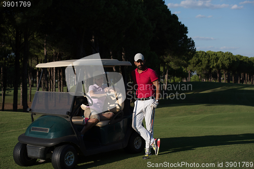 Image of couple in buggy on golf course