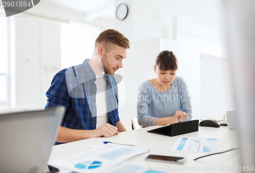 Image of creative team with tablet pc and papers at office