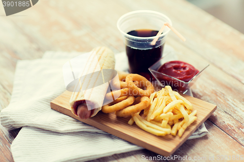 Image of close up of fast food snacks and drink on table