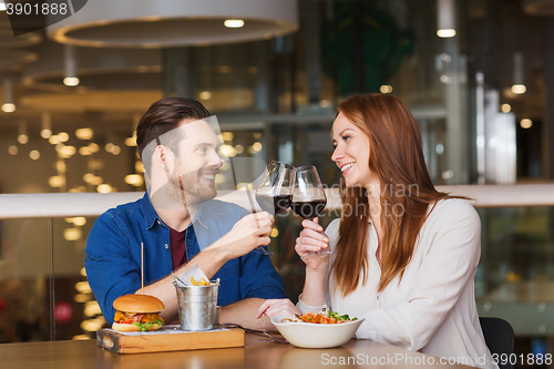 Image of happy couple dining and drink wine at restaurant