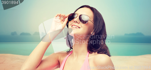 Image of happy woman in sunglasses and swimsuit