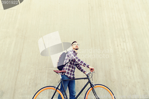 Image of hipster man with fixed gear bike and backpack