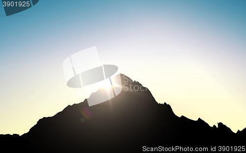 Image of silhouette of mountain top over sky and sun light